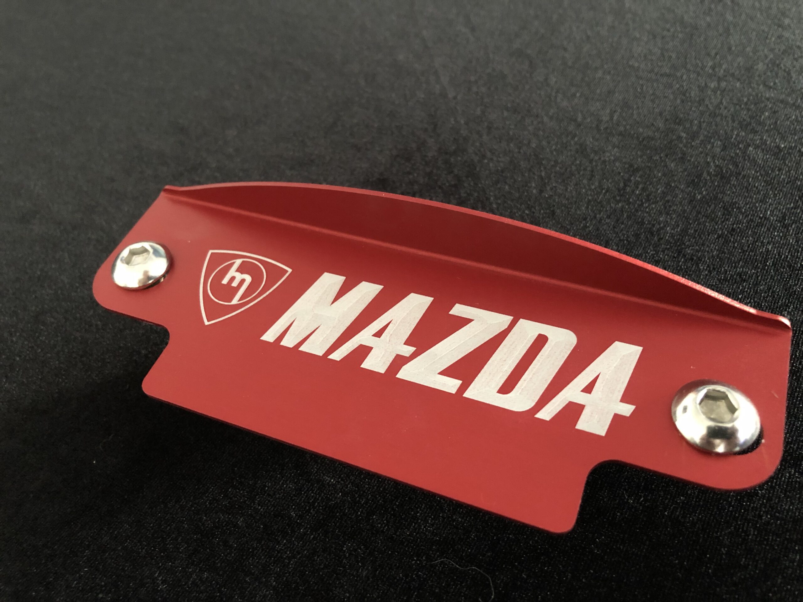Red M Mazda fly wheel cover